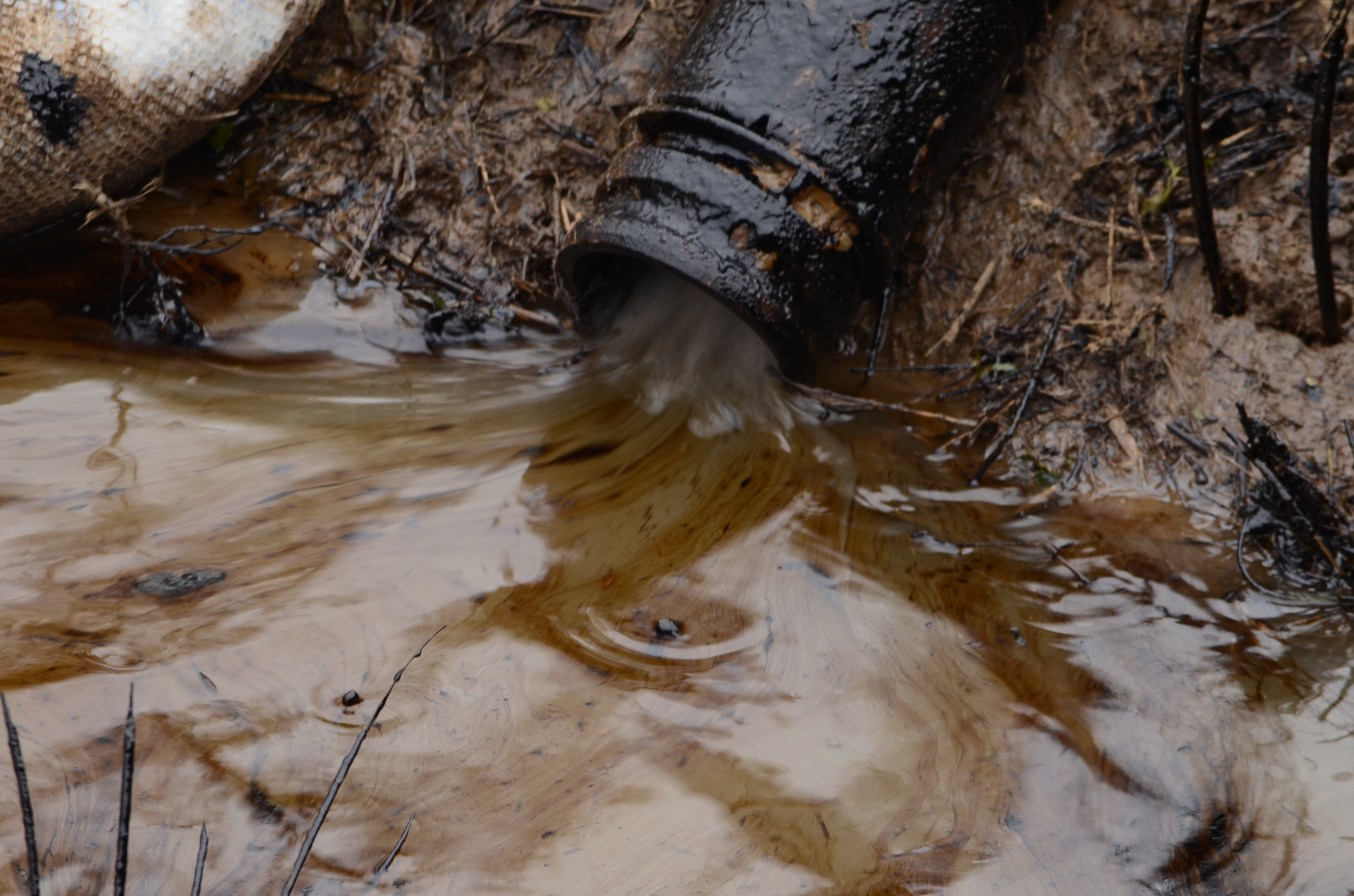 A shot of tar sands from the Arkansas spill pumped into a containment pond